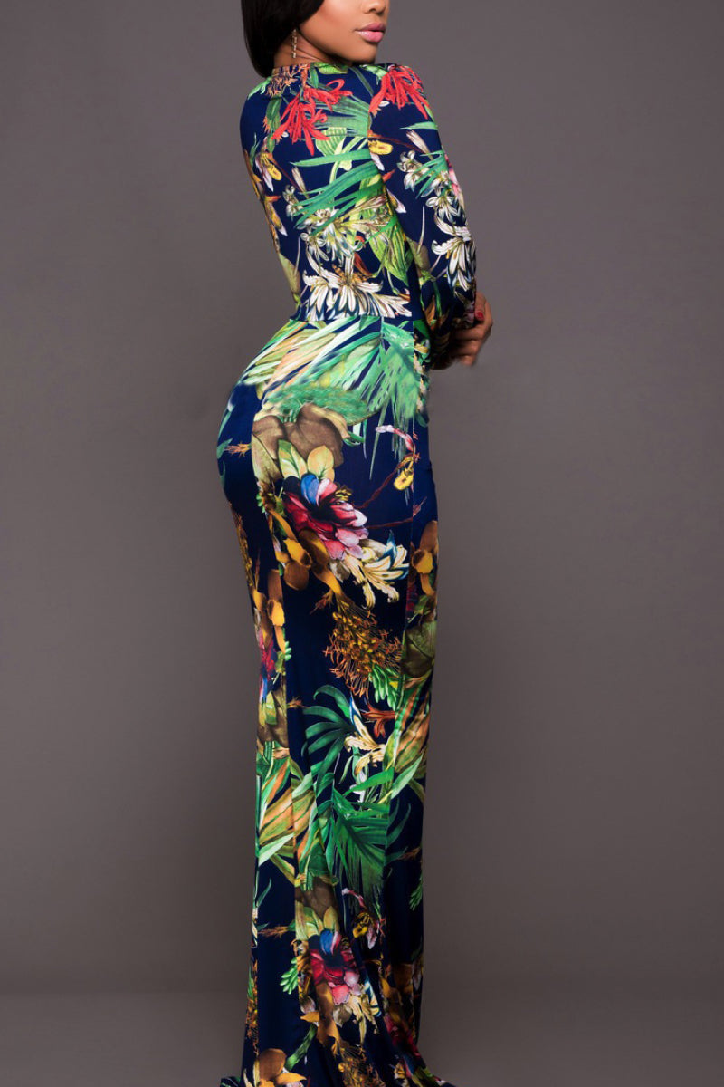 Side view of a woman wearing a printed plunge neck leg split maxi dress. The dress features a plunging neckline, showcasing subtle elegance, while a thigh-high leg split adds a touch of allure.