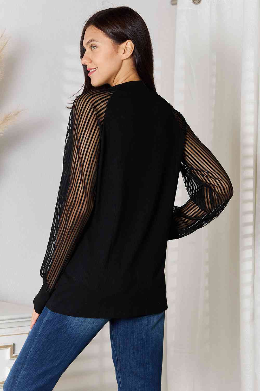 Back view of sheer long sleeve black blouse