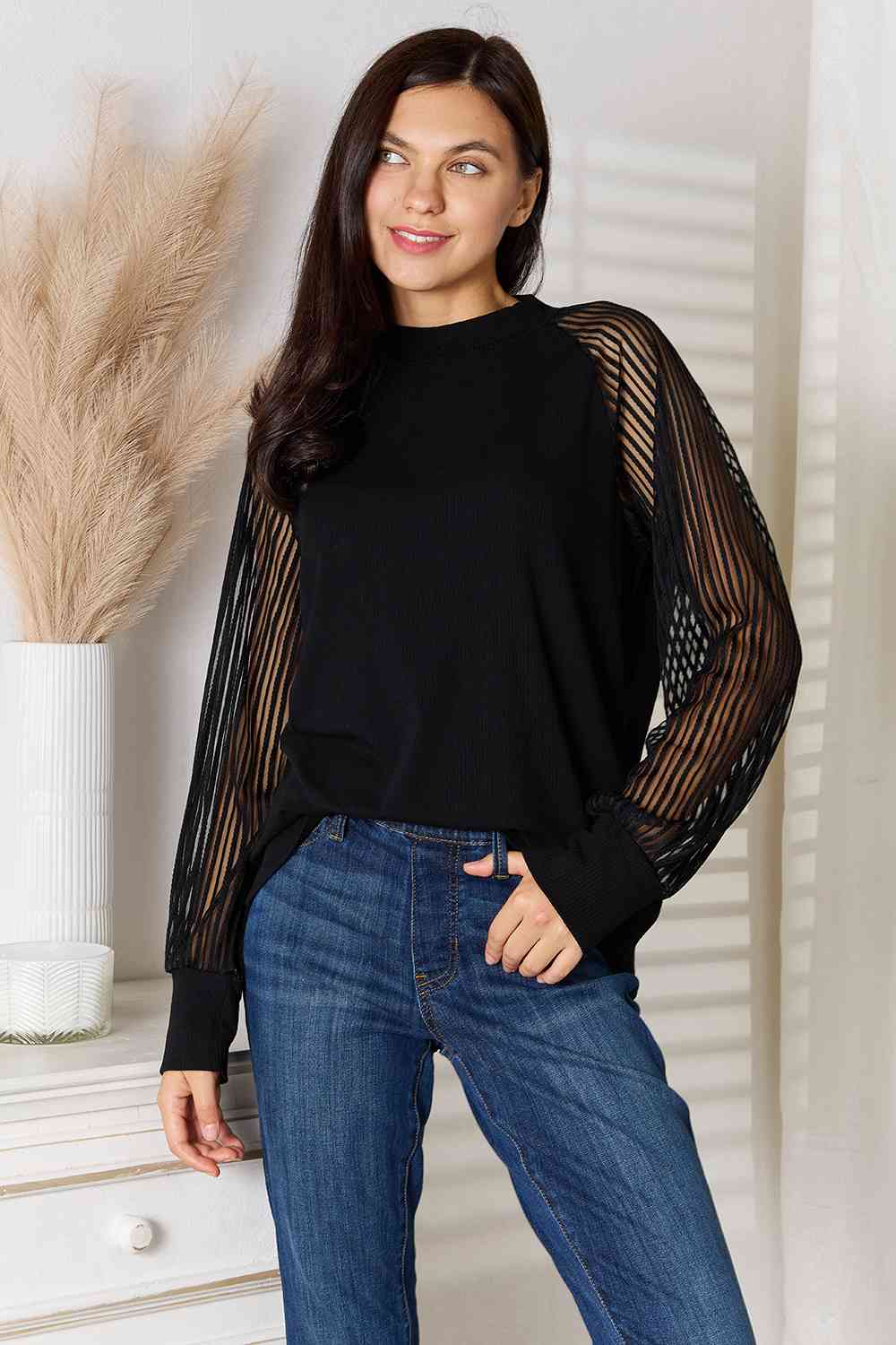 Front view of sheer long sleeve black blouse 