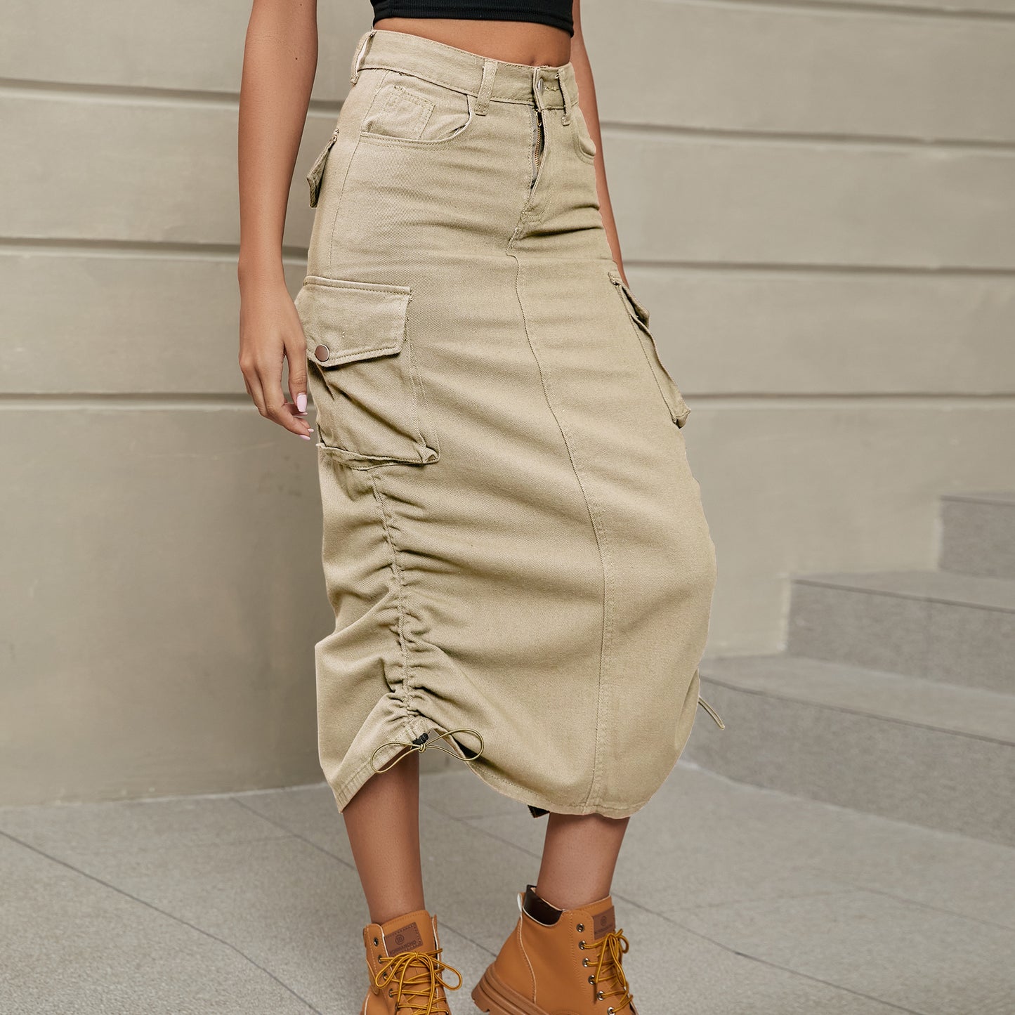 Model left facing view wearing drawstring ruched skirt in the color sand