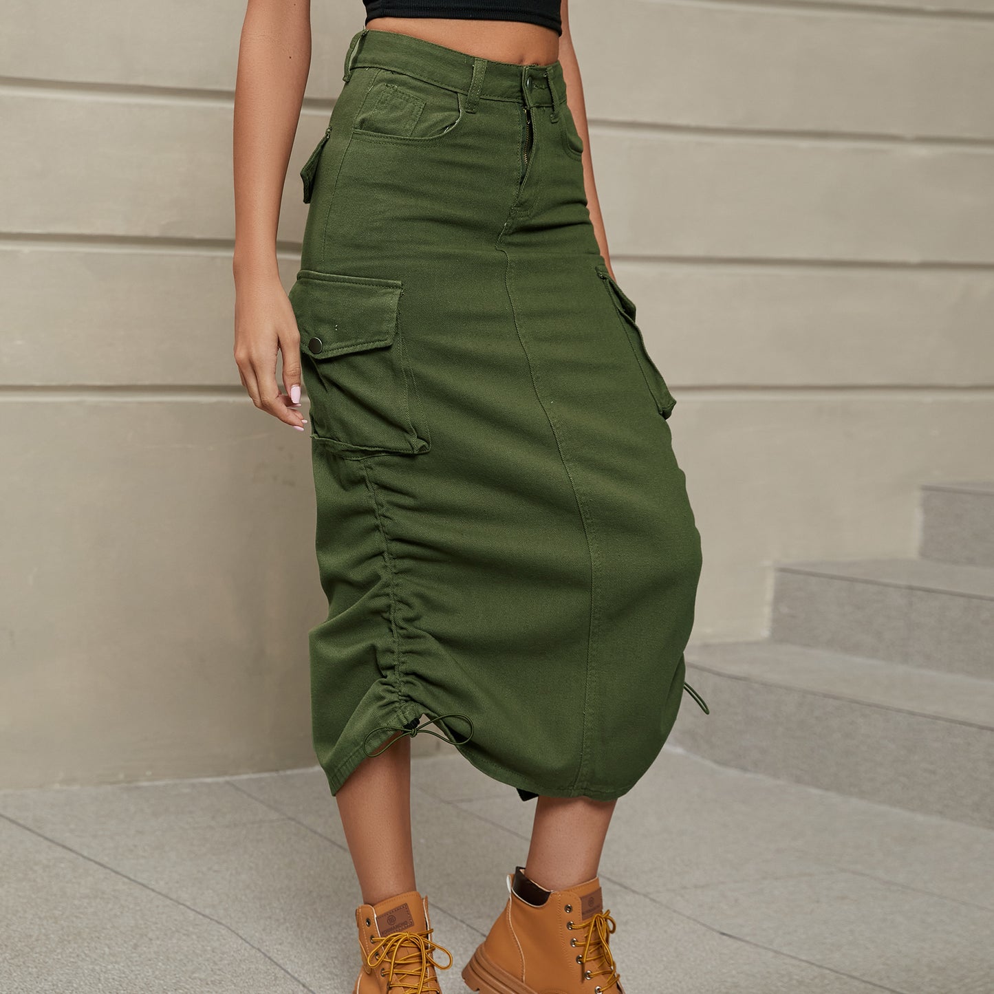 Front facing view of model wearing drawstring ruched skirt in the color army green. 