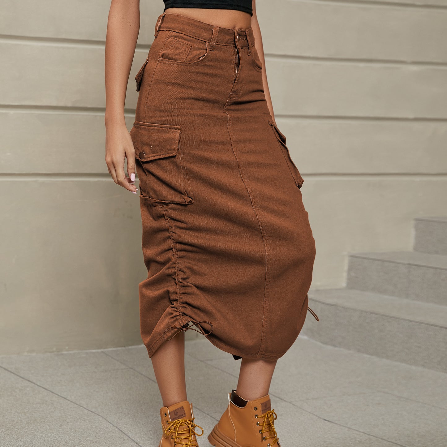 Front left facing view of model wearing drawstring ruched skirt in the color chestnut 