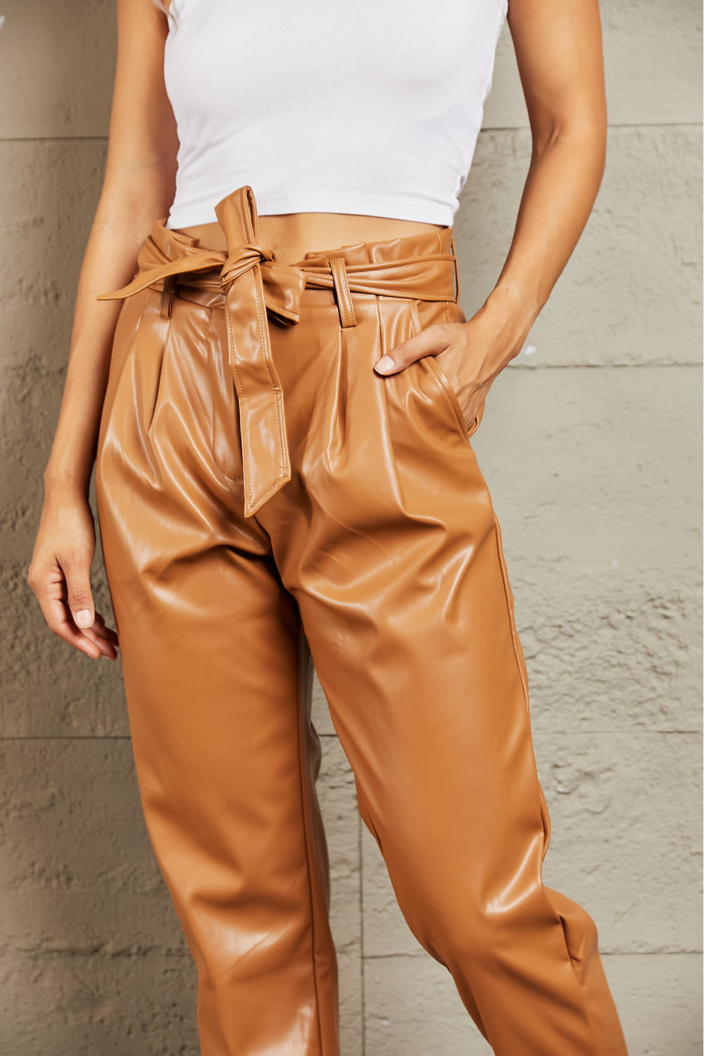 Front view of model wearing Heyson Faux Leather Paperbag Pants