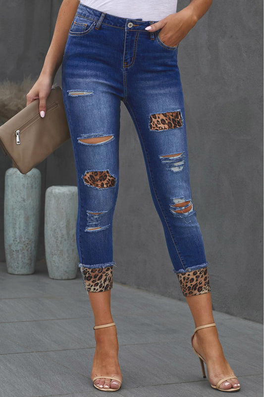Front facing view of model wear leopard print denim distressed cropped jeans.