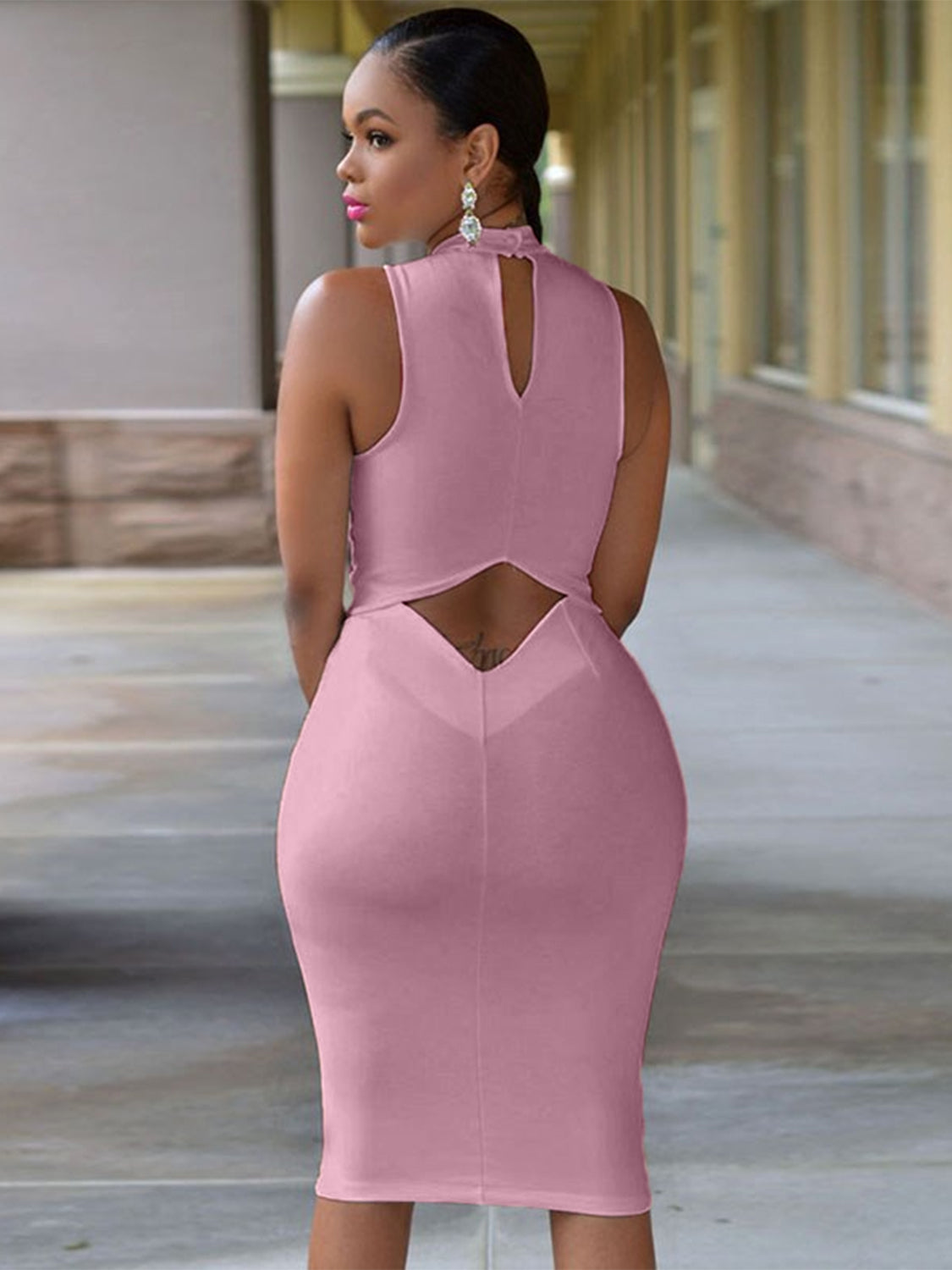 Back view of model wearing Cutout Mock Neck Sleeveless Dress in the color blush pink