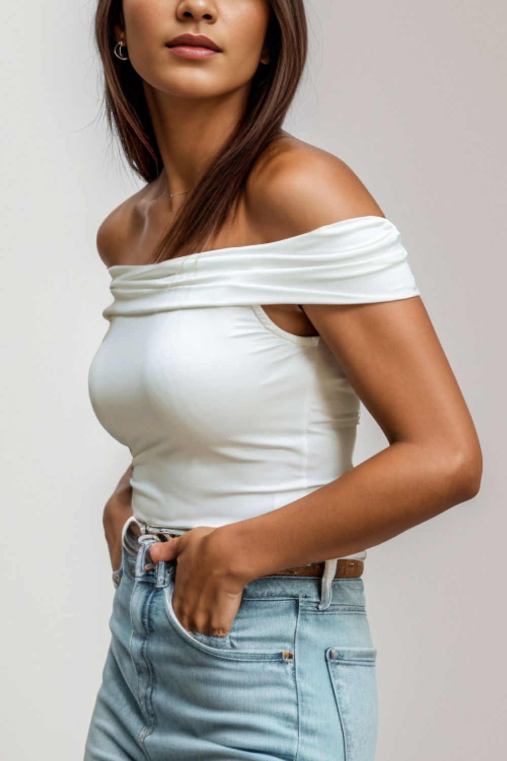 Side view of off shoulder trendy blouse in white.