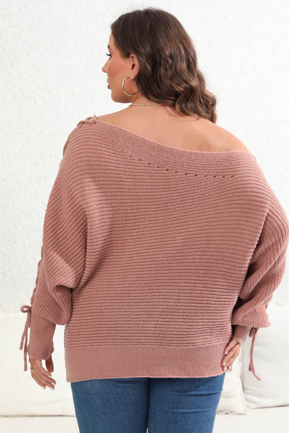 Model back view wearing Plus Size One Shoulder Beaded Sweater in the color dusty pink