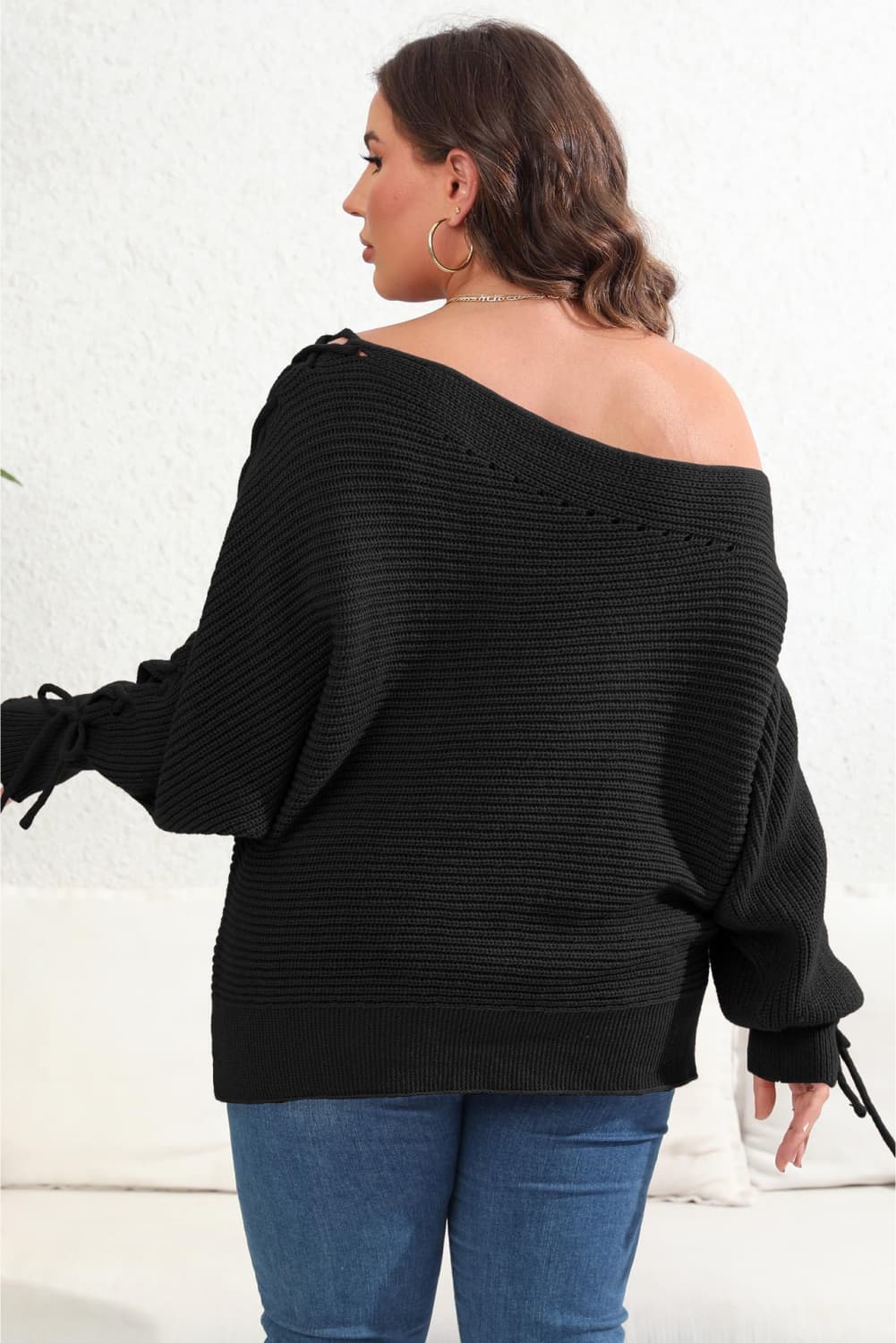 Model back view wearing Plus Size One Shoulder Beaded Sweater in the color black