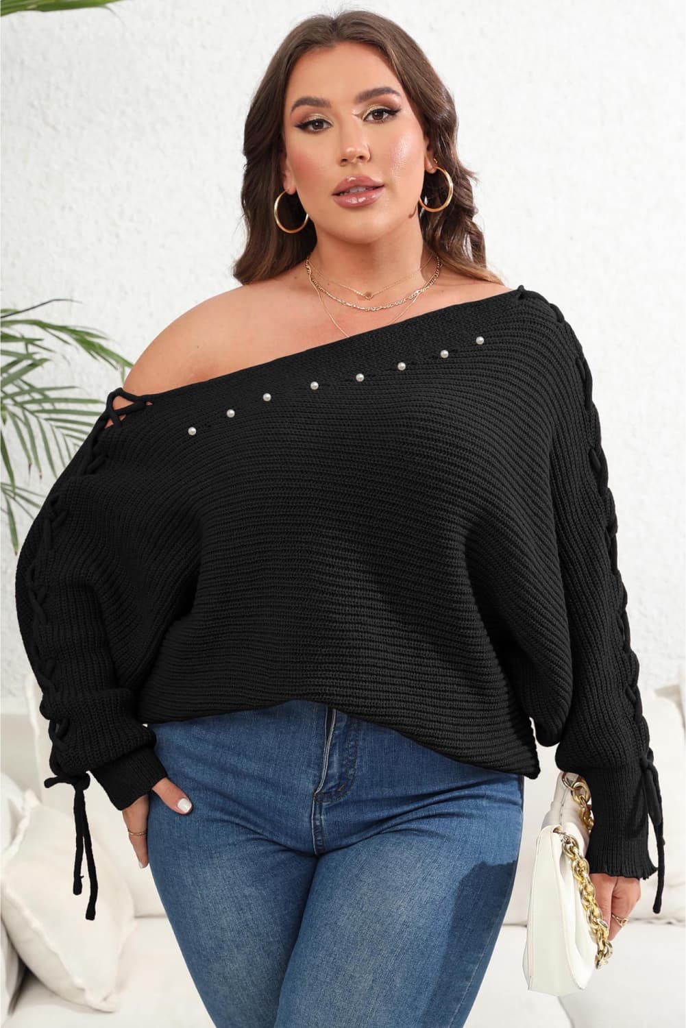 Model front view wearing Plus Size One Shoulder Beaded Sweater in the color black
