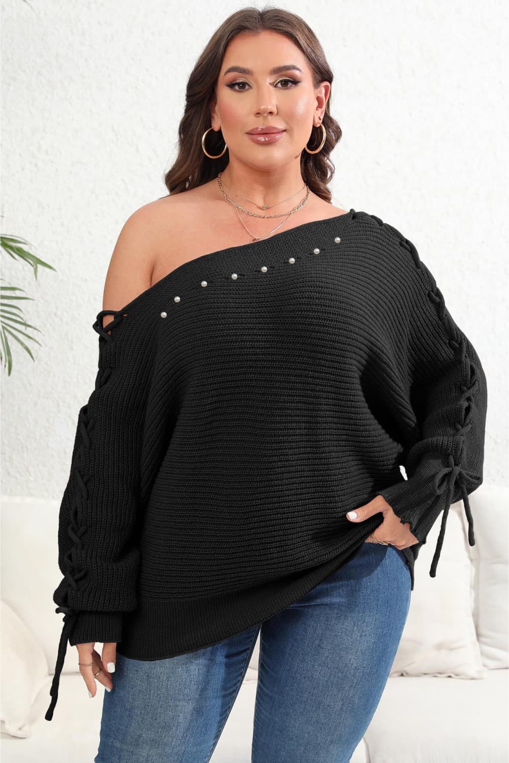 Model front view wearing Plus Size One Shoulder Beaded Sweater in the color black