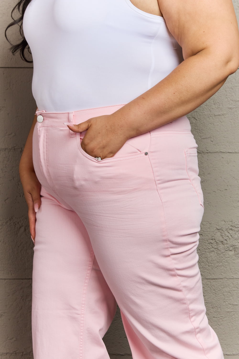 Side view of plus size RISEN Raelene Full Size High Waist Wide Leg Jeans in Light Pink