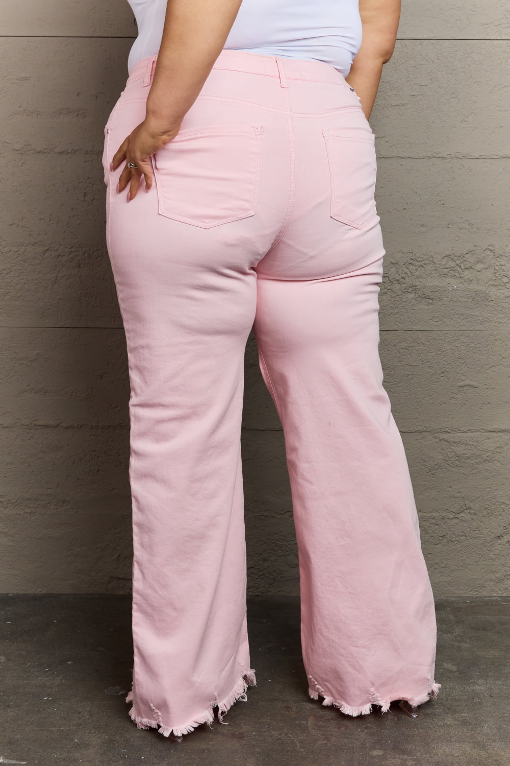 Back view of Plus Size RISEN Raelene Full Size High Waist Wide Leg Jeans in Light Pink 