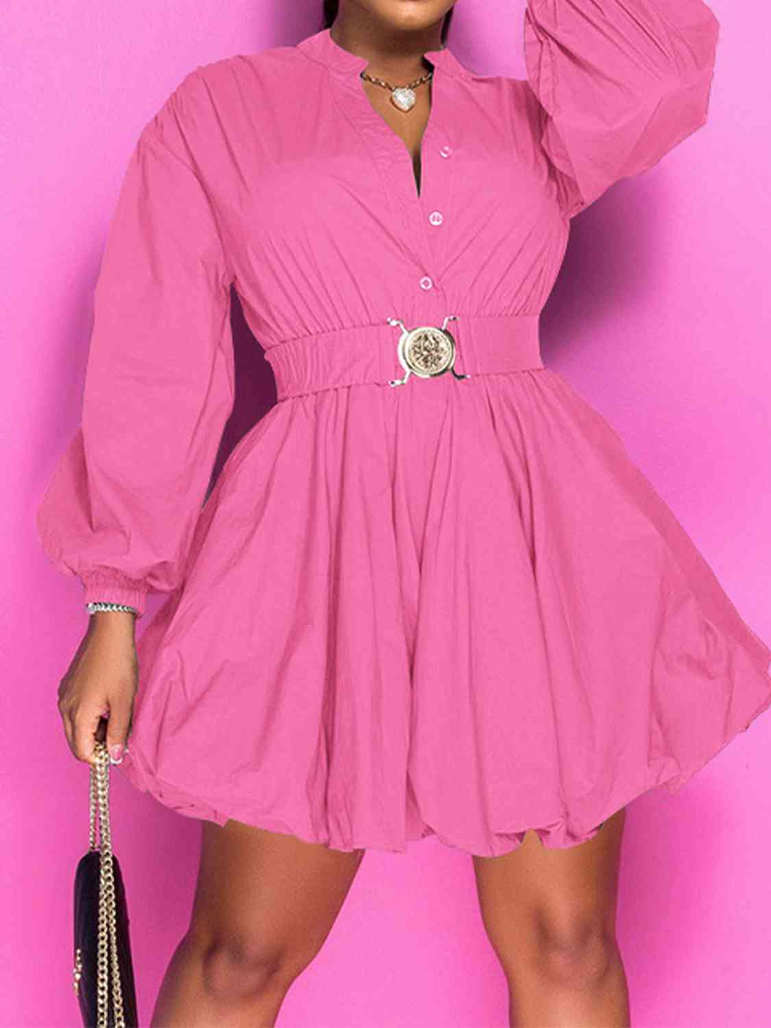 Front view of model wearing notched button up ballon sleeve dress in fuchsia pink  