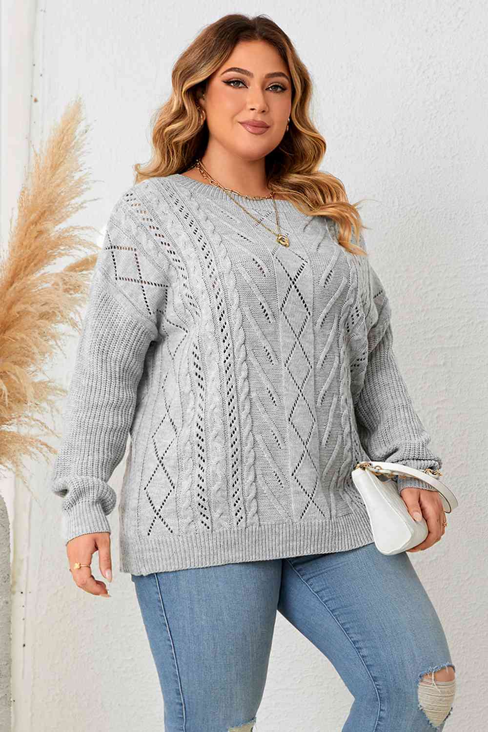 Model wearing Plus Size Cold Shoulder Asymmetrical Cable-Knit Top