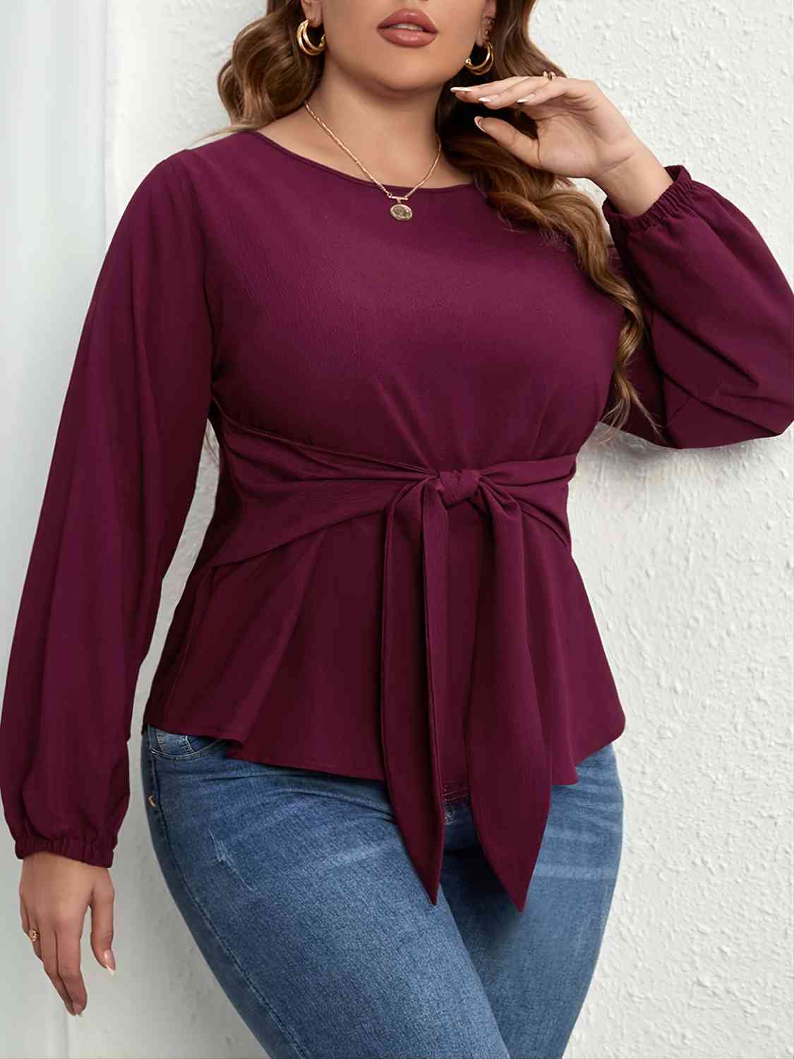 Model wearing Plus Size Tie Front Long Sleeve Blouse