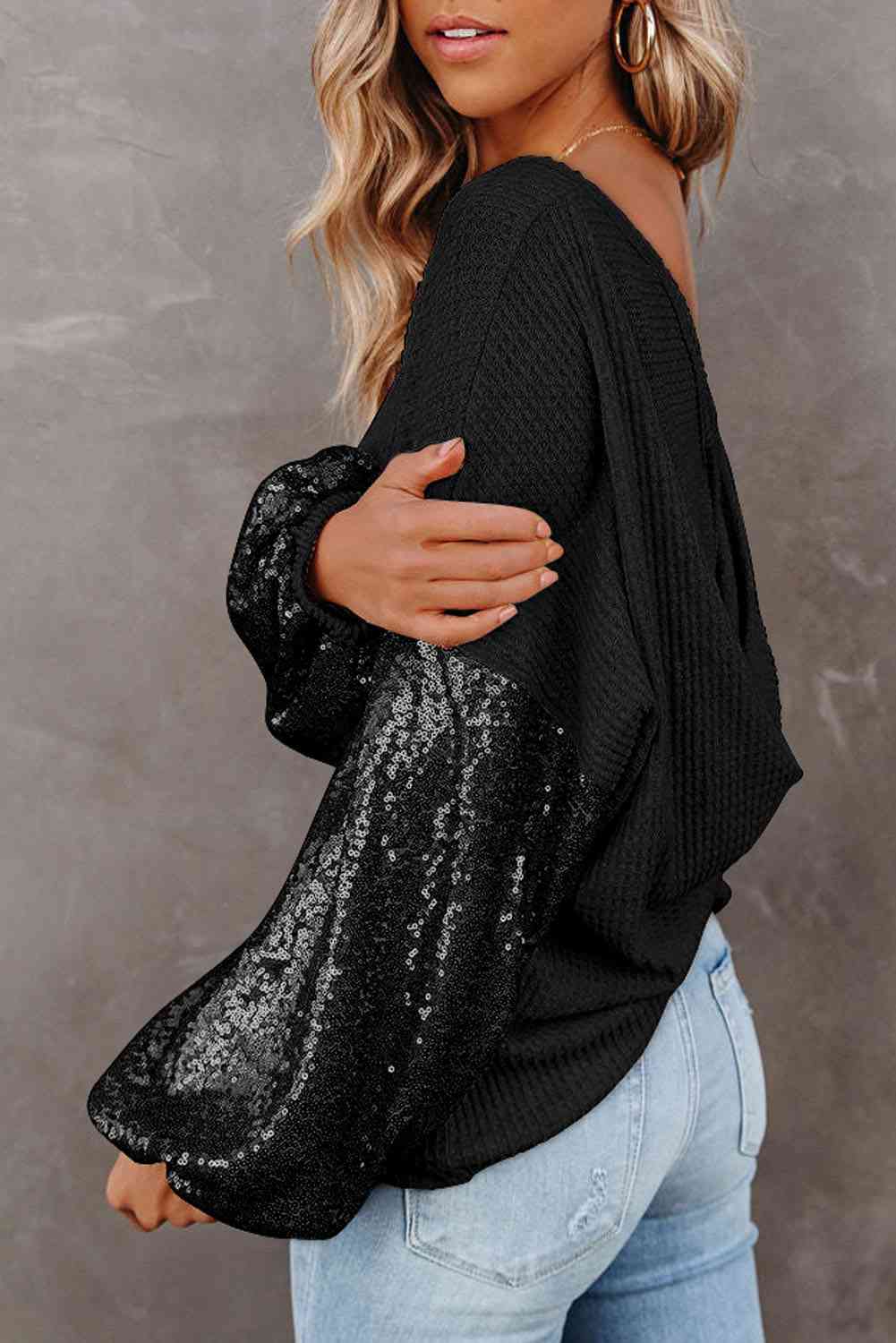 Model from the side view wearing Sequin Sparkling Long sleeve Blouse in the color black 
