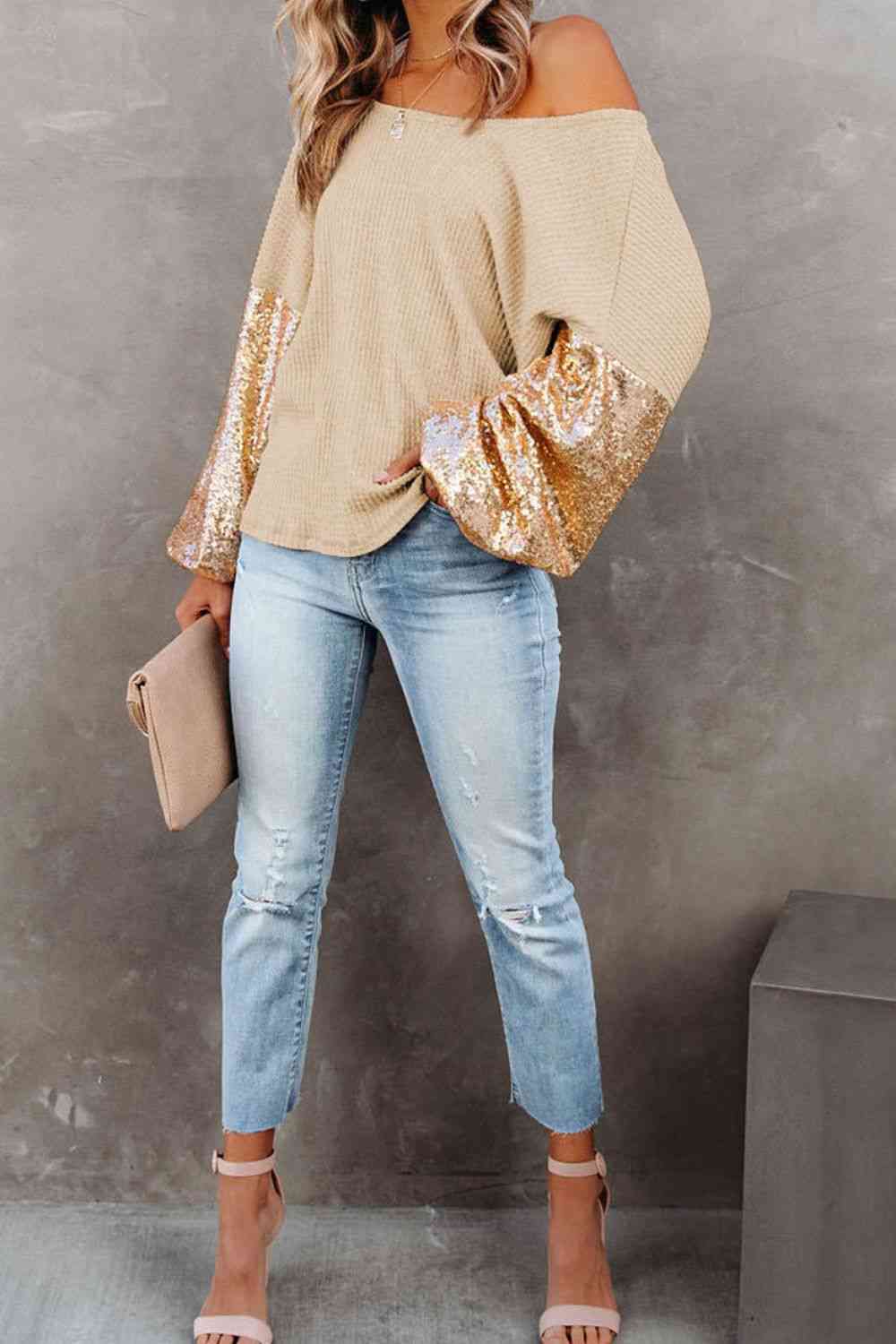 Front view of model wearing sequin sleeve waffle knit blouse in the color sand