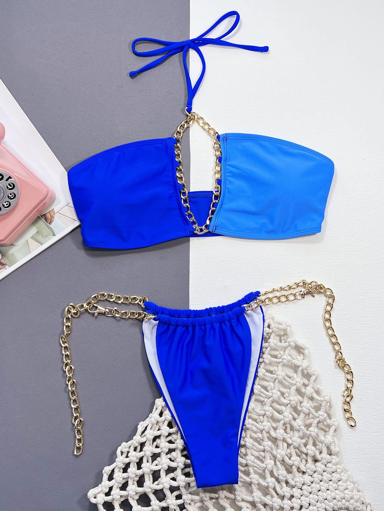 Flatlay view of the front of The Exclusive Emerald Chain Detail Halter Neck Bikini Set, displaying the bikini's detailed design and halter neck style on a flat surface for a comprehensive overview.